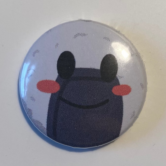 Round button badge with a cartoon character on a white background